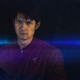 James (Harry Shum Jr.) behind a camera at the end of his rope in Broadcast Signal Intrusion.